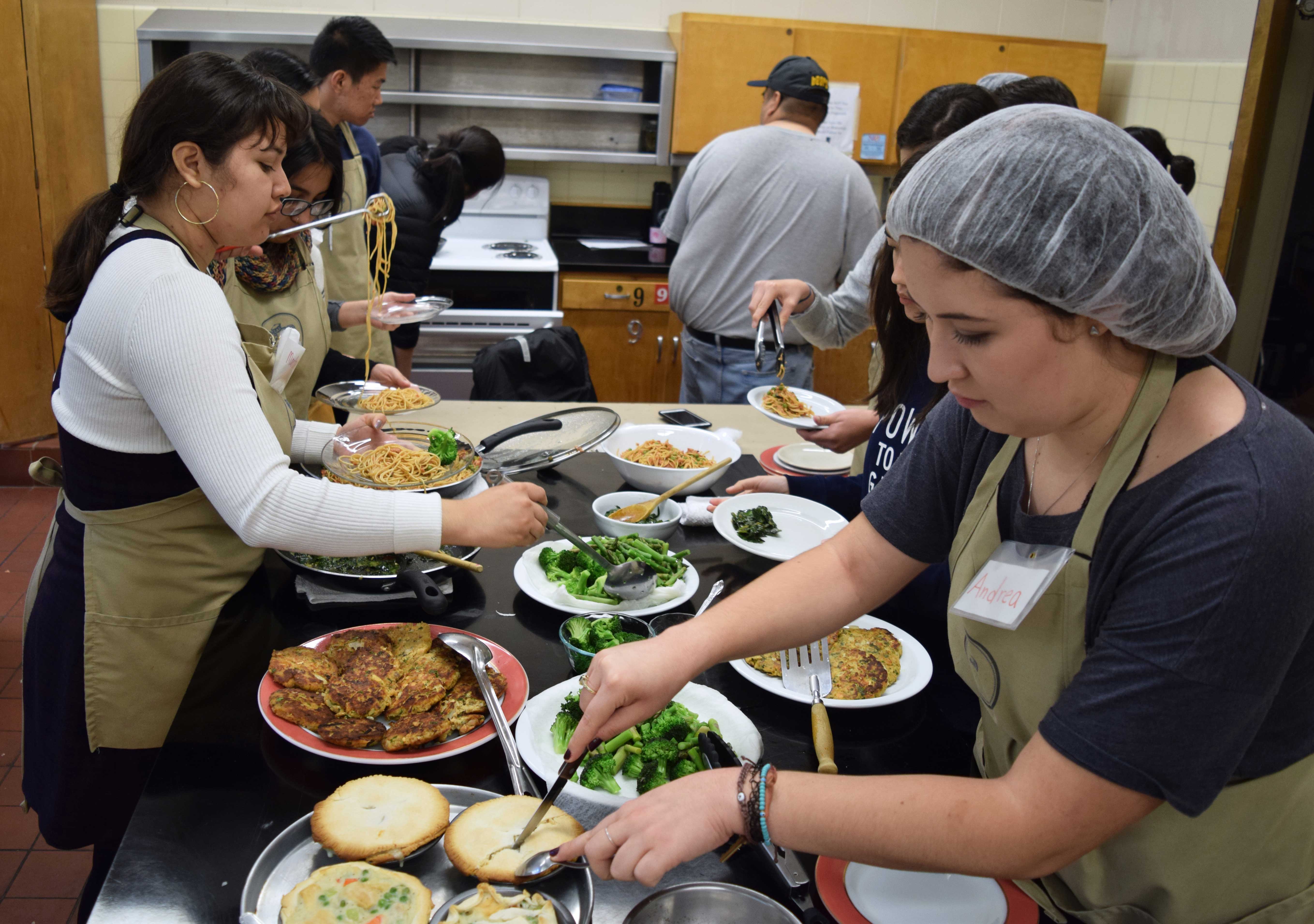 Students cooking in the UC Berkeley teaching kitchen.