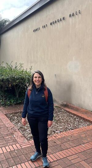 A photo of Yesim Goktekin standing in front of the wall of a building