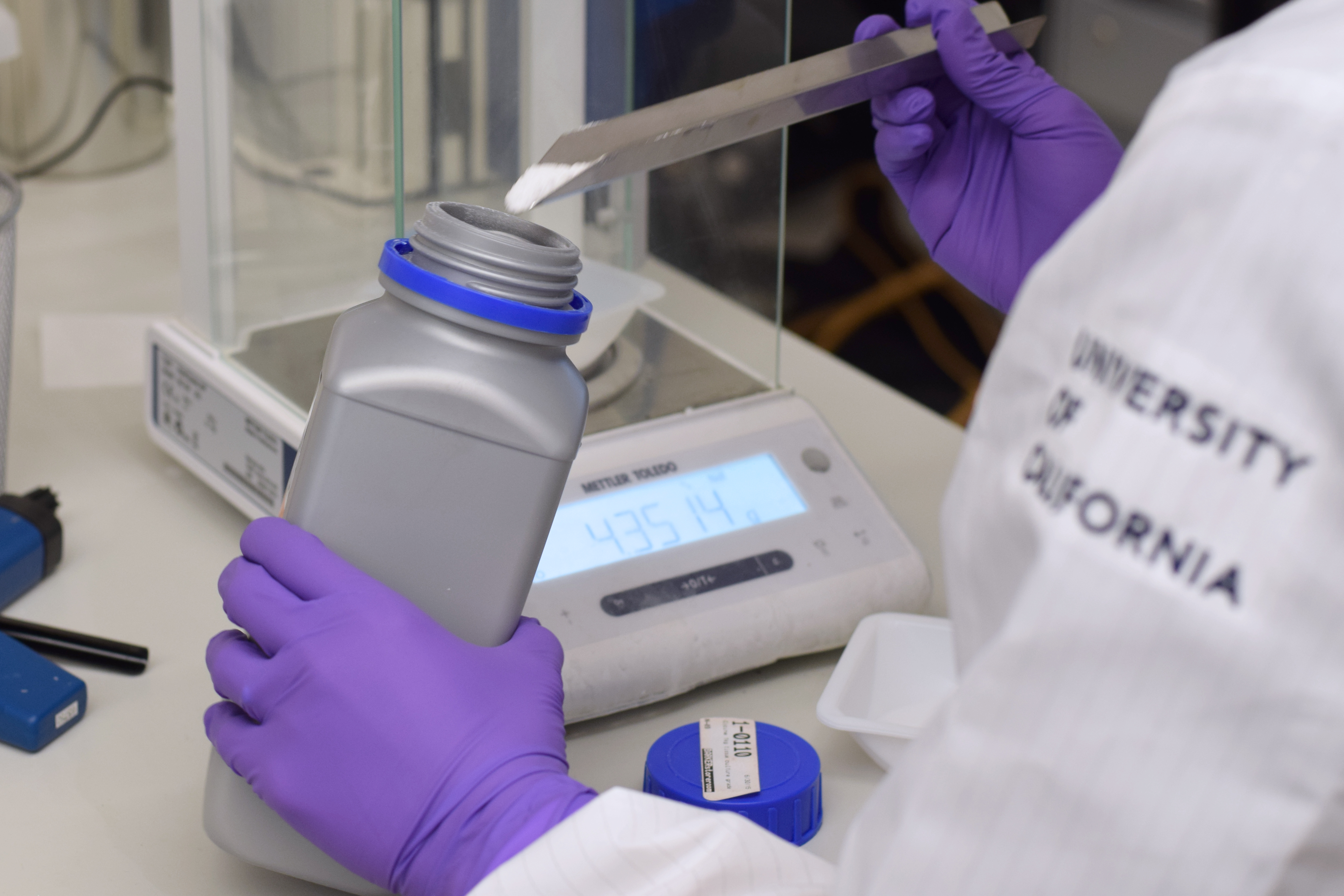 Closeup of a researcher's hands weighing something 