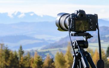 A camera taking a photo of a scenic landscape
